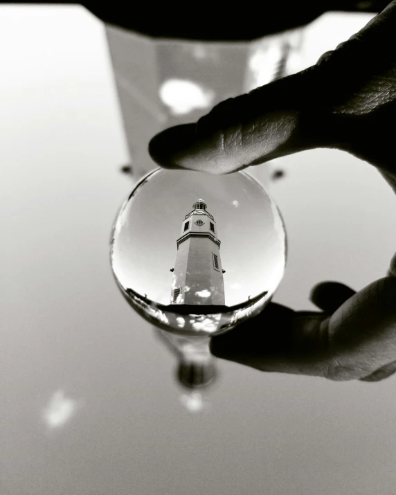 a glass ball with a lighthouse inside of it