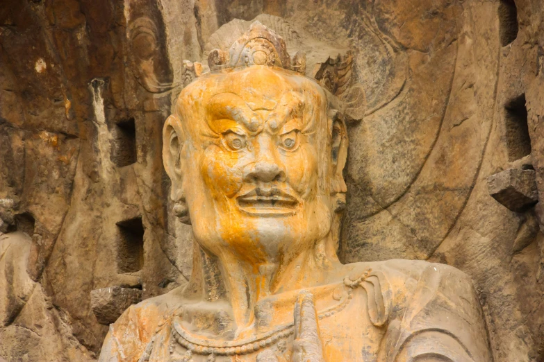 a large stone statue made to look like a face in a cave