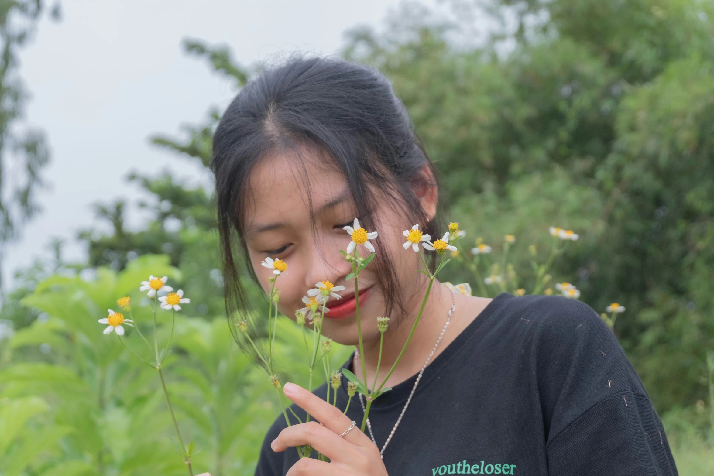 a  smelling a bouquet of daisies