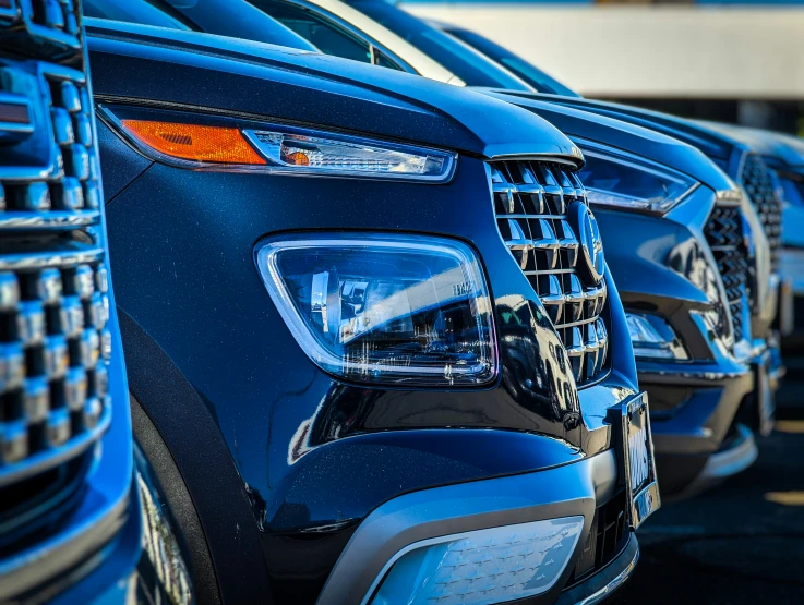 line of new cars parked in a lot