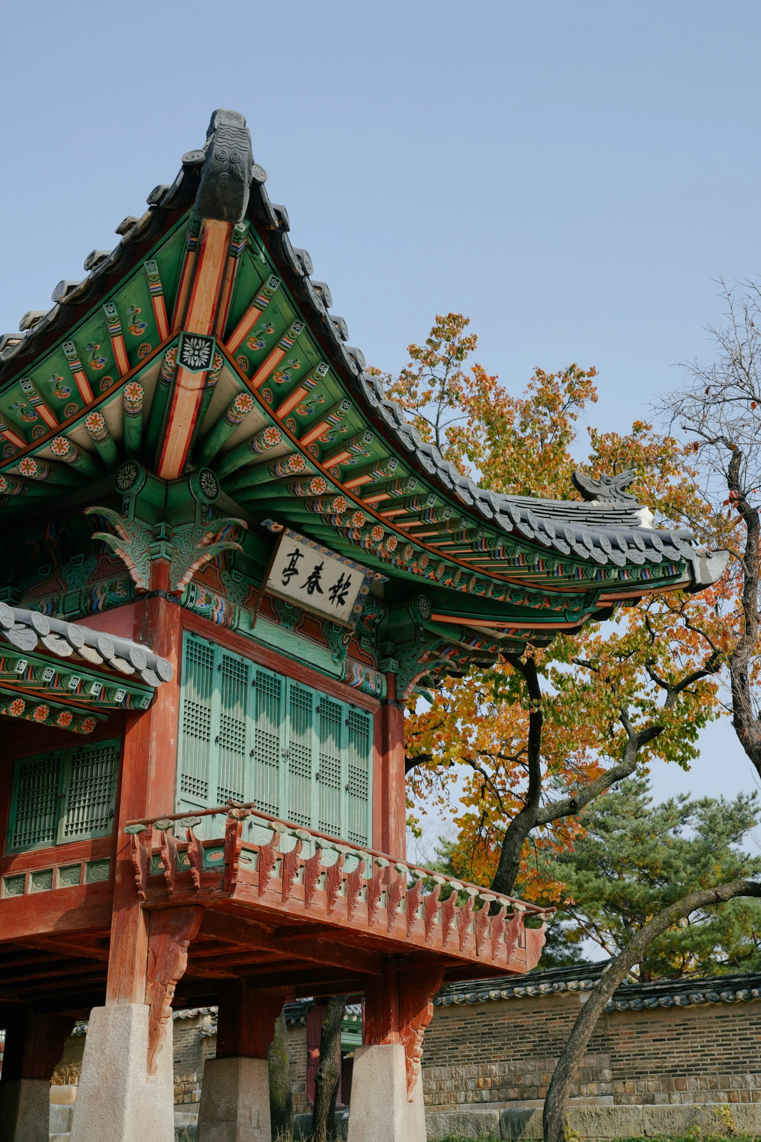 a tall tower with an ornate roof and a small statue underneath it