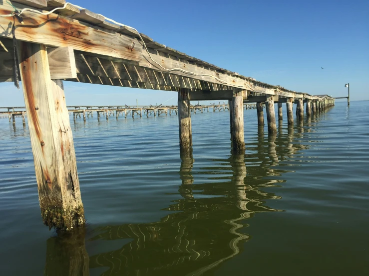 a long wooden pier sticking out of the water