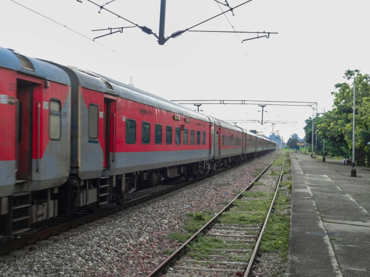 a red train sitting next to a train station