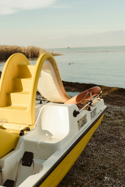 a yellow boat with its open front steps in water