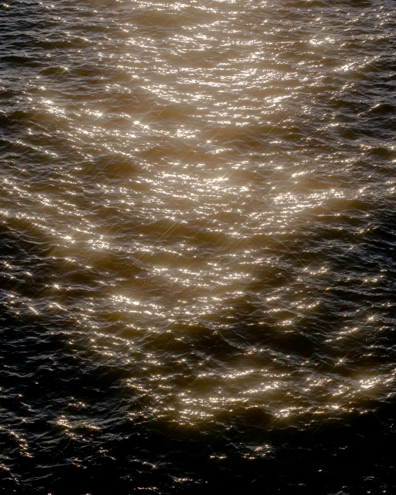 a ship in the middle of water surrounded by ripples