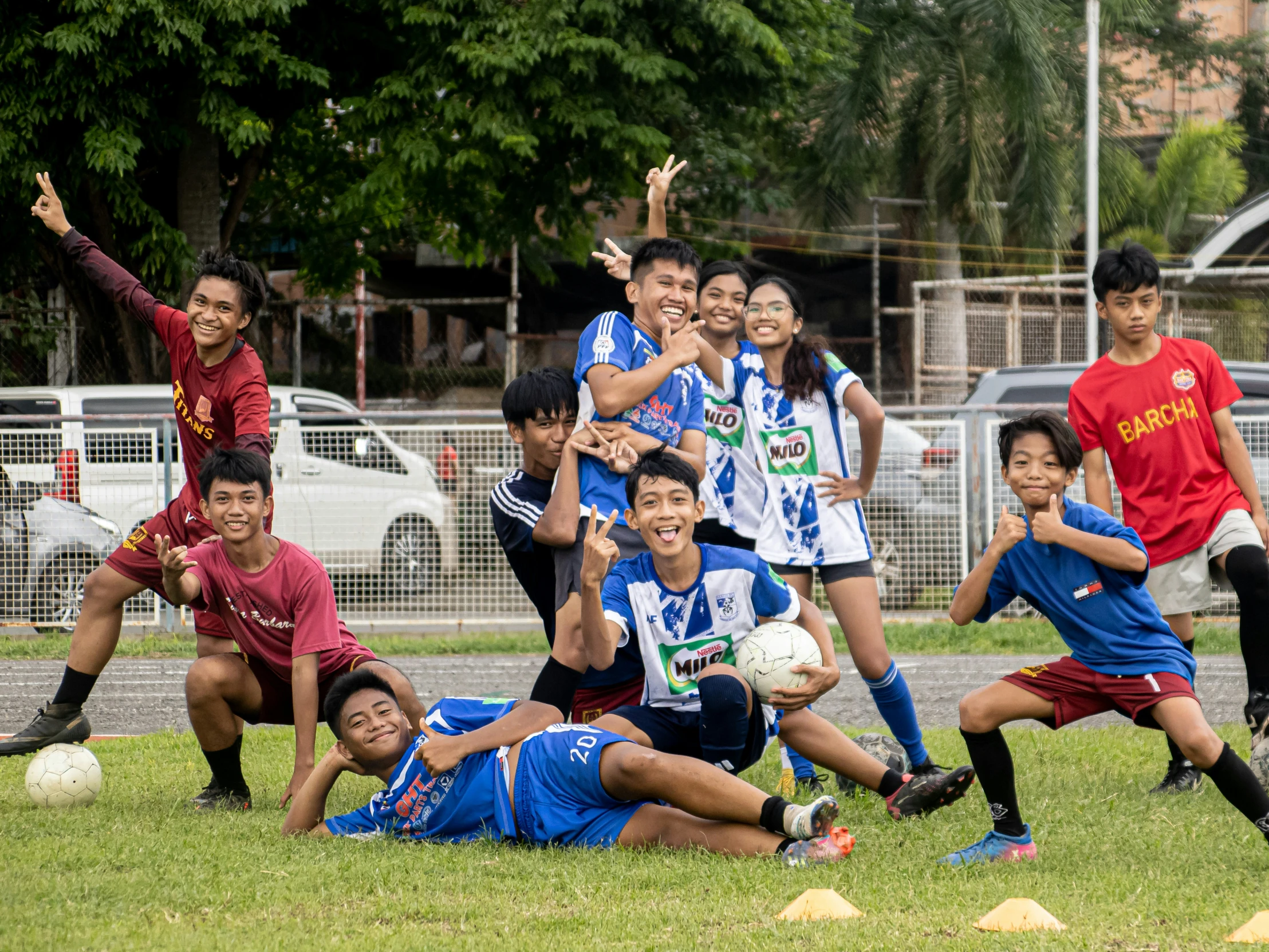 soccer players posing for a group po with the ball in front of them