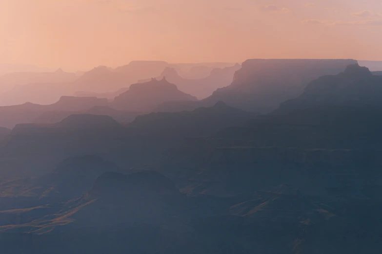 an empty plane flying above the rocky mountains