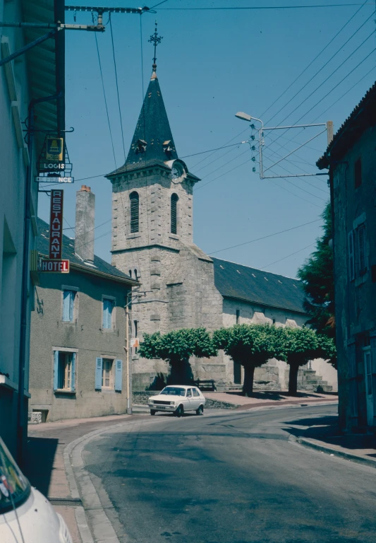 the tower has a clock on it as well as a street sign