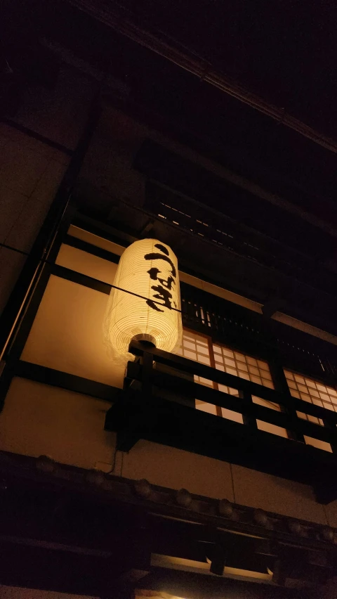 an asian - inspired lamp at the entrance of a building