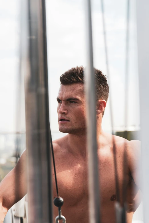 a man with  on stands near some boats