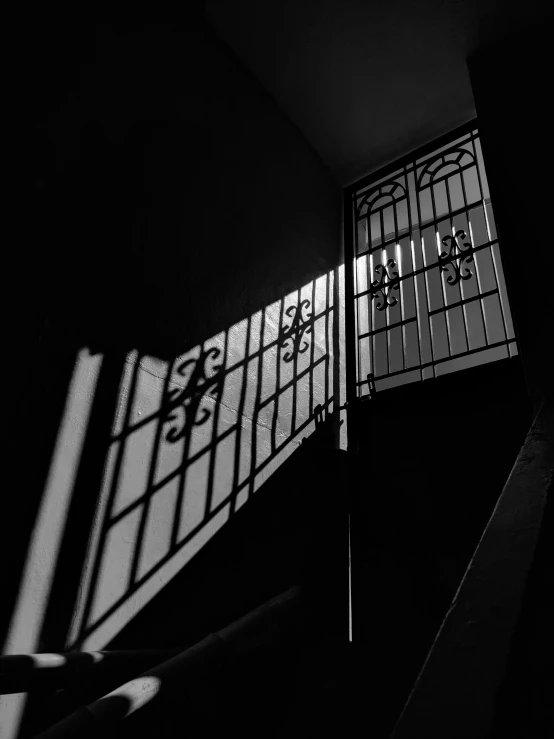 the shadows of windows in an open stairwell