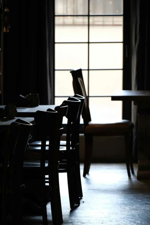 a dining table set for six, in front of a large window