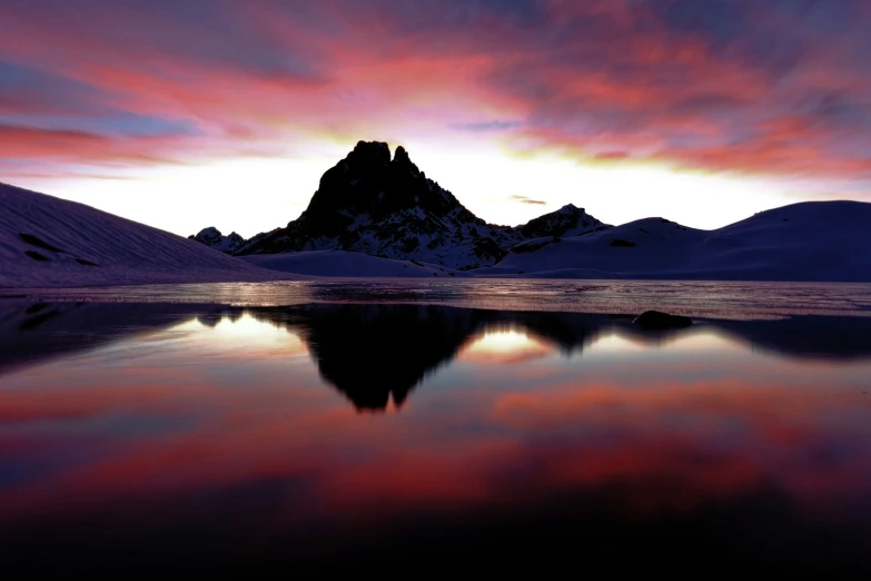 an iceberg sits on the edge of a large lake