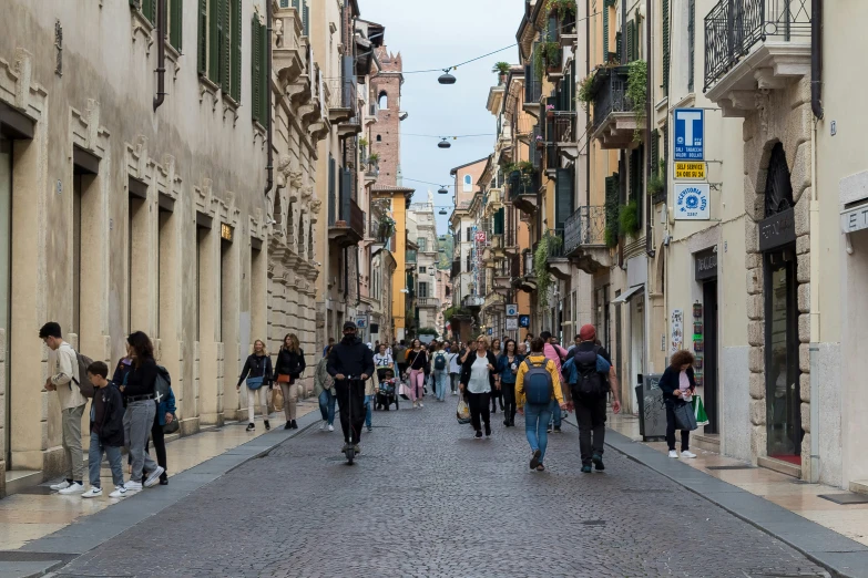 a street scene shows several people walking through the alley