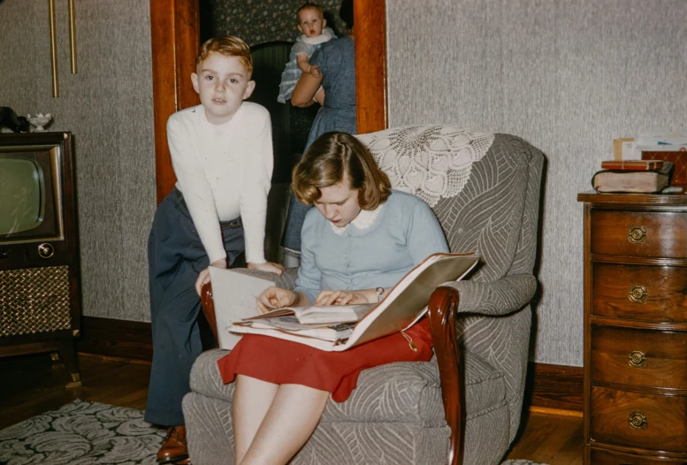 a woman is sitting down with a book near her