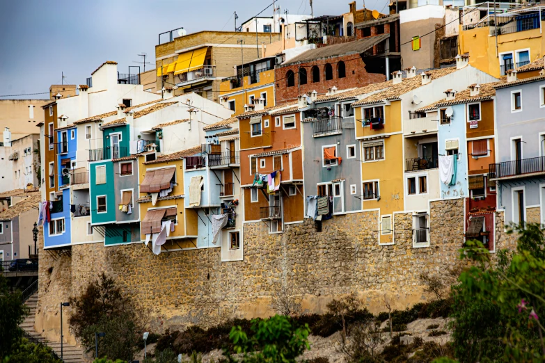 an image of a city on a hill with lots of buildings