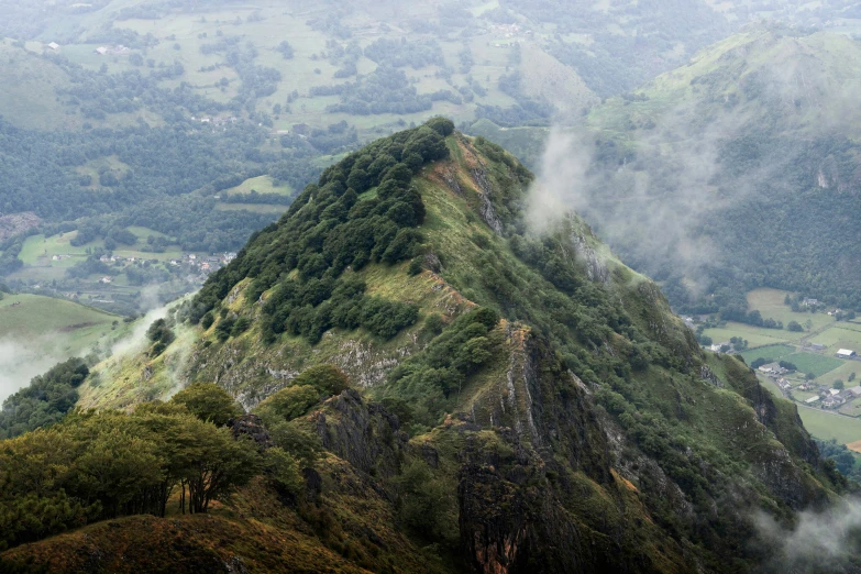 some very big mountains with some trees on them