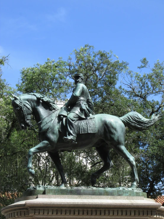 the equestrian statue is a monument with a statue of a seated lady on a horse