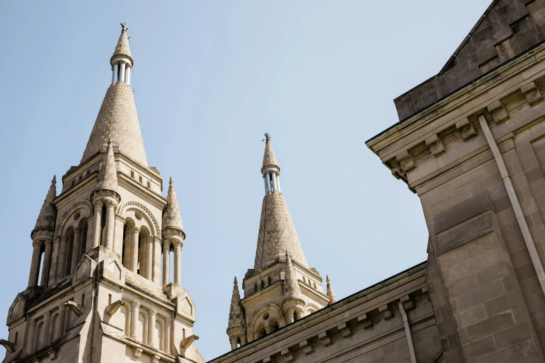 an old cathedral is standing in front of a bright blue sky