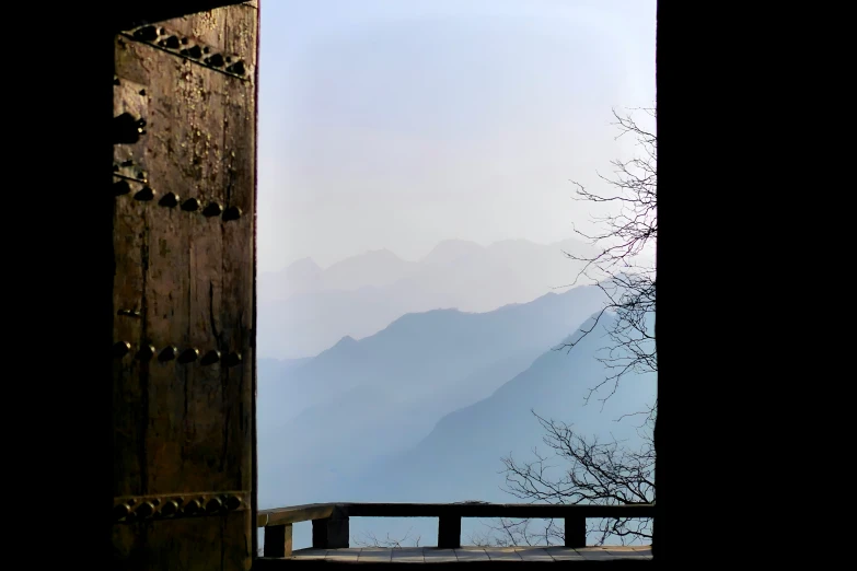 a mountain view from behind an open window