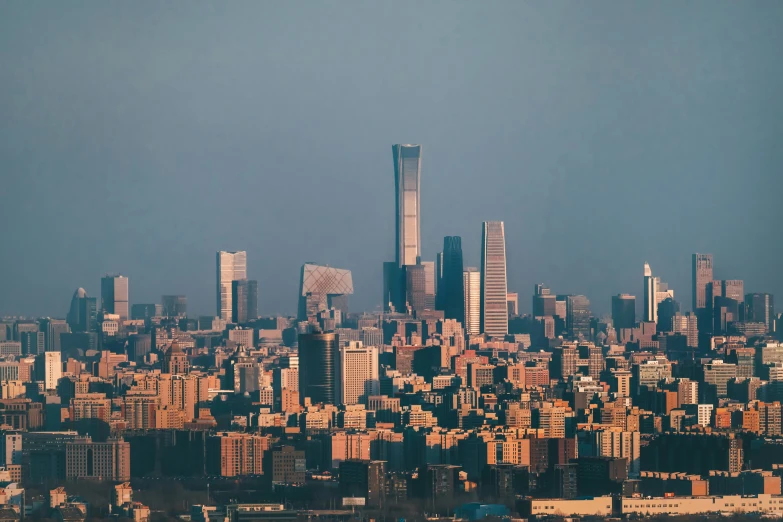 the city skyline has tall skyscrs against a gray sky