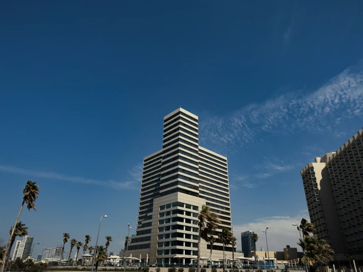 a very tall building stands next to other tall buildings