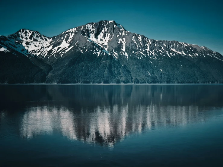 a large mountain range sitting next to a body of water