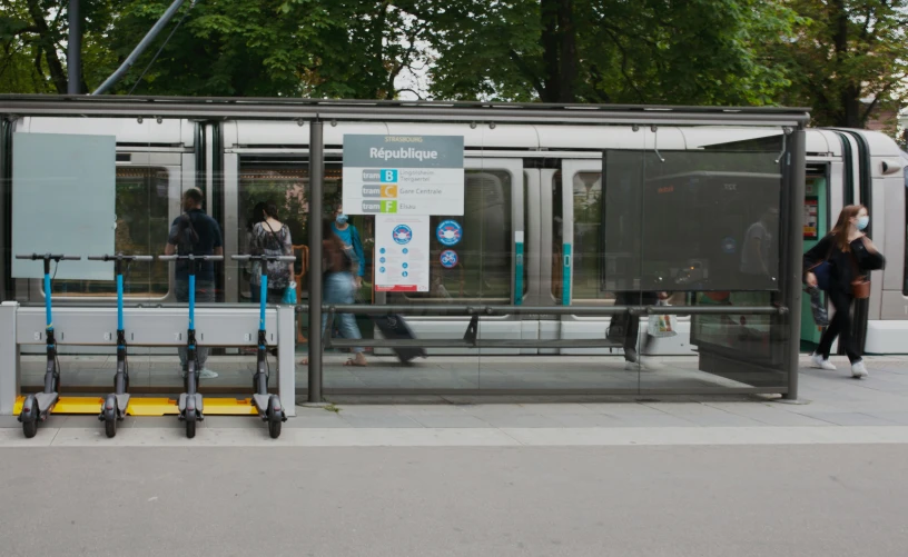 a bus stop with people waiting to get on or off it