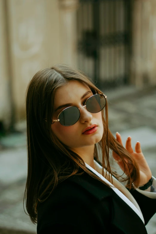 a woman with glasses on is posing for the camera