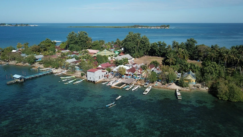 a small island surrounded by boats in the water