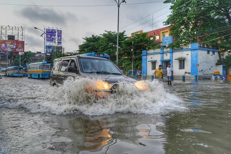 a van drives through water during a city street