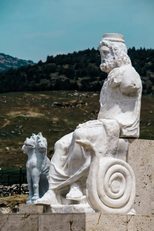 a large white statue of a man sitting in front of a dog