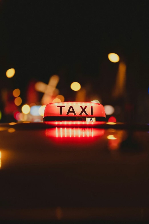 a taxi sign is lit up at night