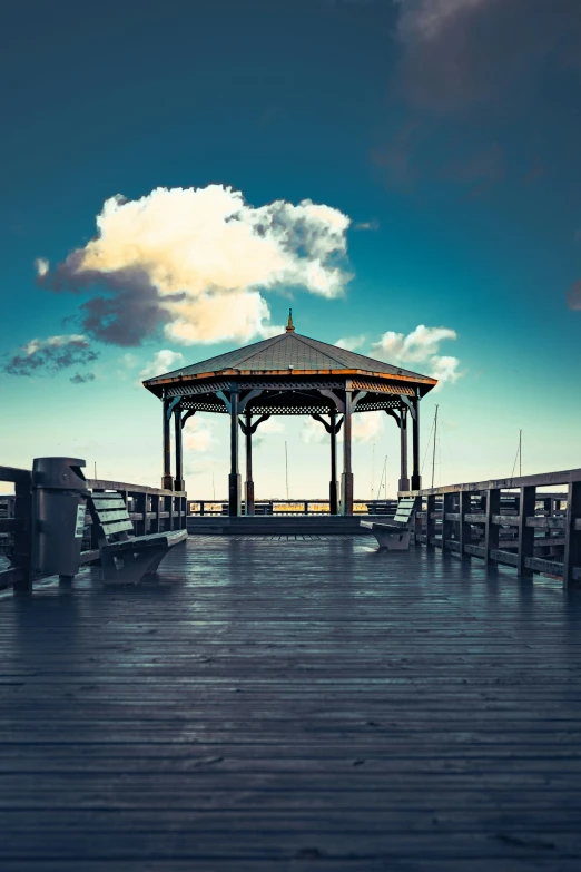 a gazebo sitting on top of a wooden pier