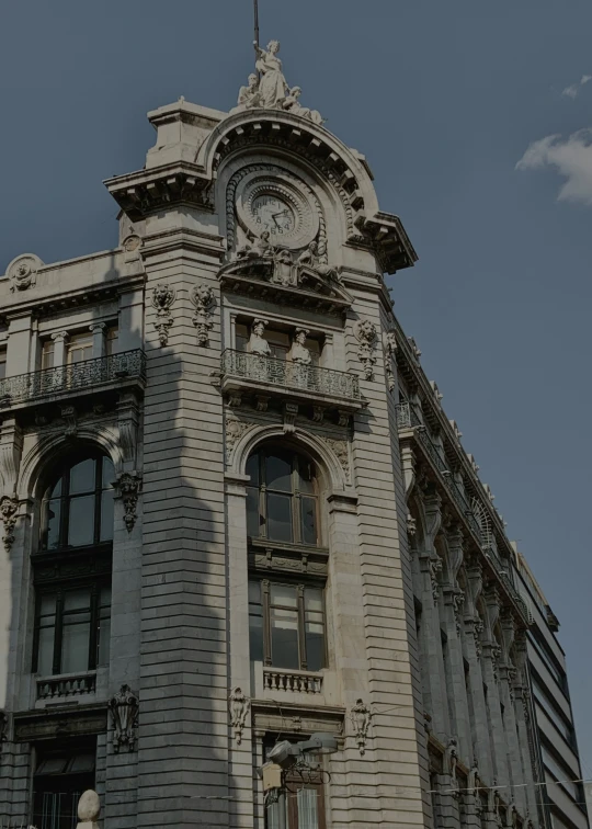 a tall building with some windows and clocks on the front