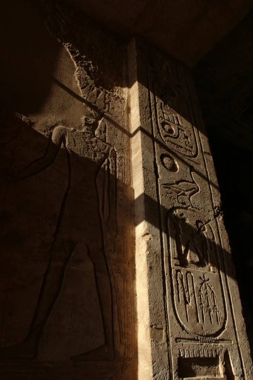 a wall in the style of egyptian art with a carving of an god