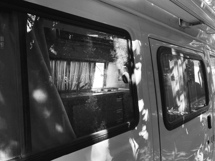 a train with its door open is sitting on the tracks