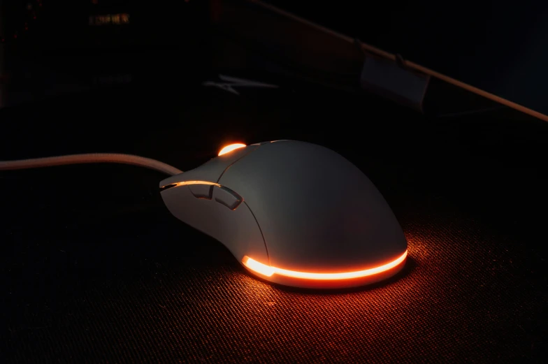 a white mouse with a red light in the bottom of it