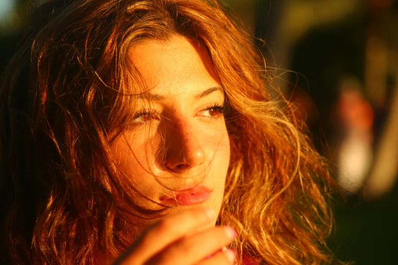 the woman with long hair is wearing a red top and a necklace