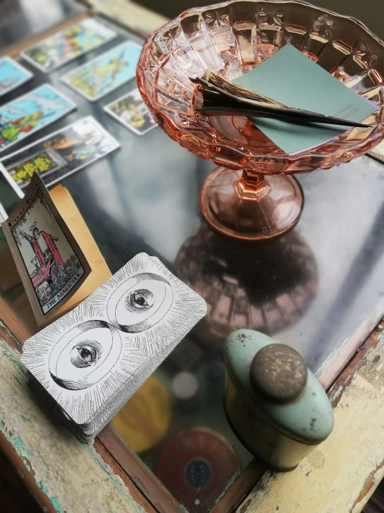 a table has two pos and a vase with a pen on top