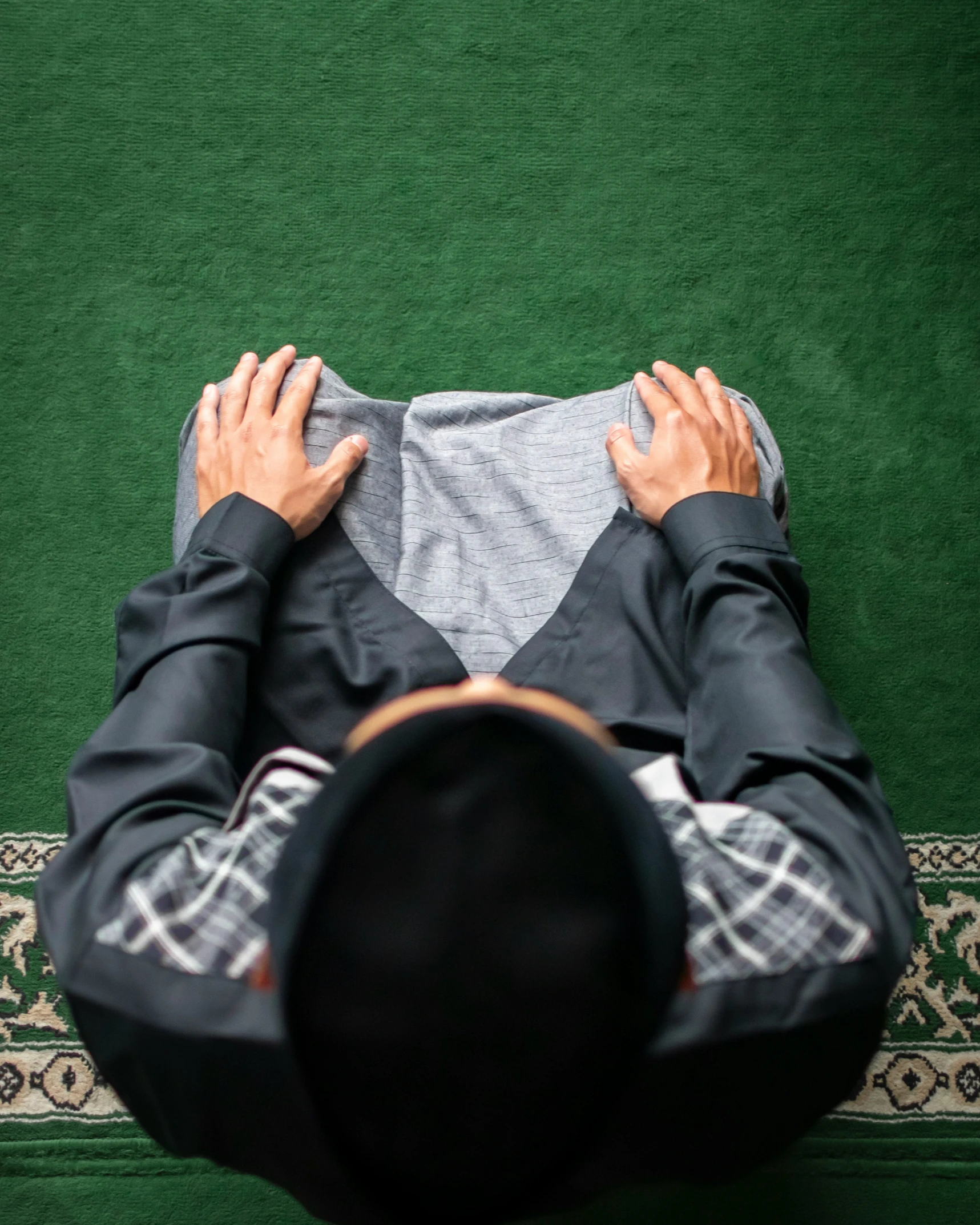 a man is shown from above laying on a rug