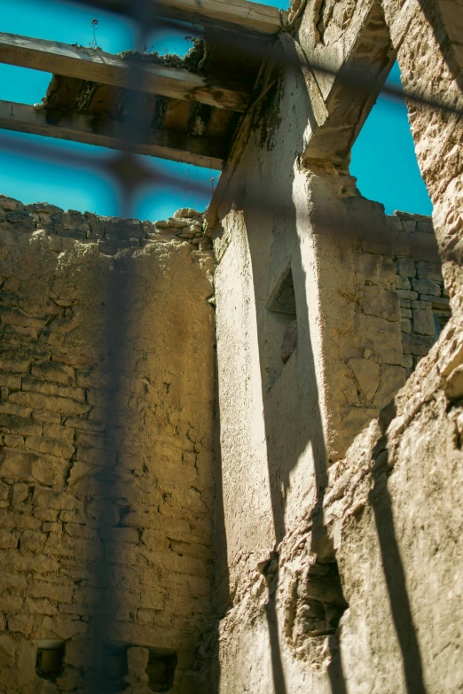 an old building with crumbling walls and a chain linked fence