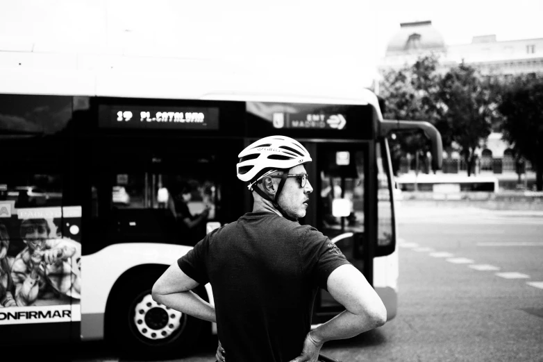 a man is waiting at a bus stop for his bus