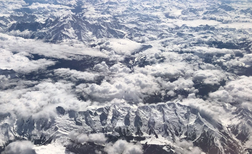 the view from an airplane shows fluffy clouds