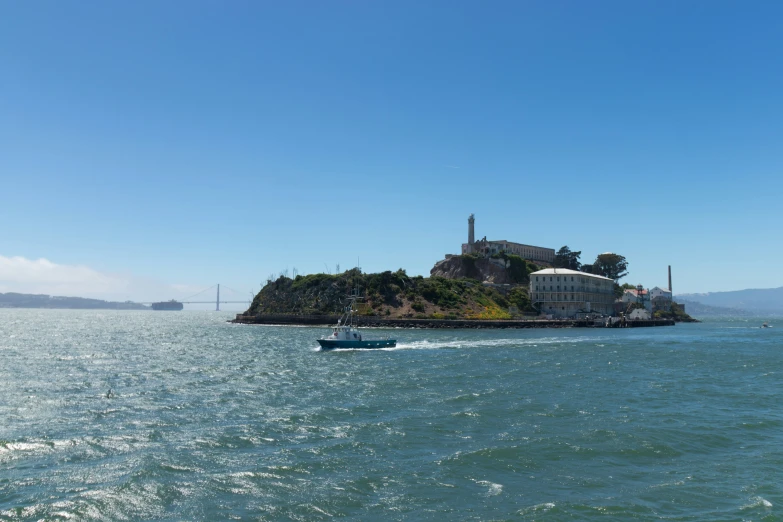 two boats moving towards the small island