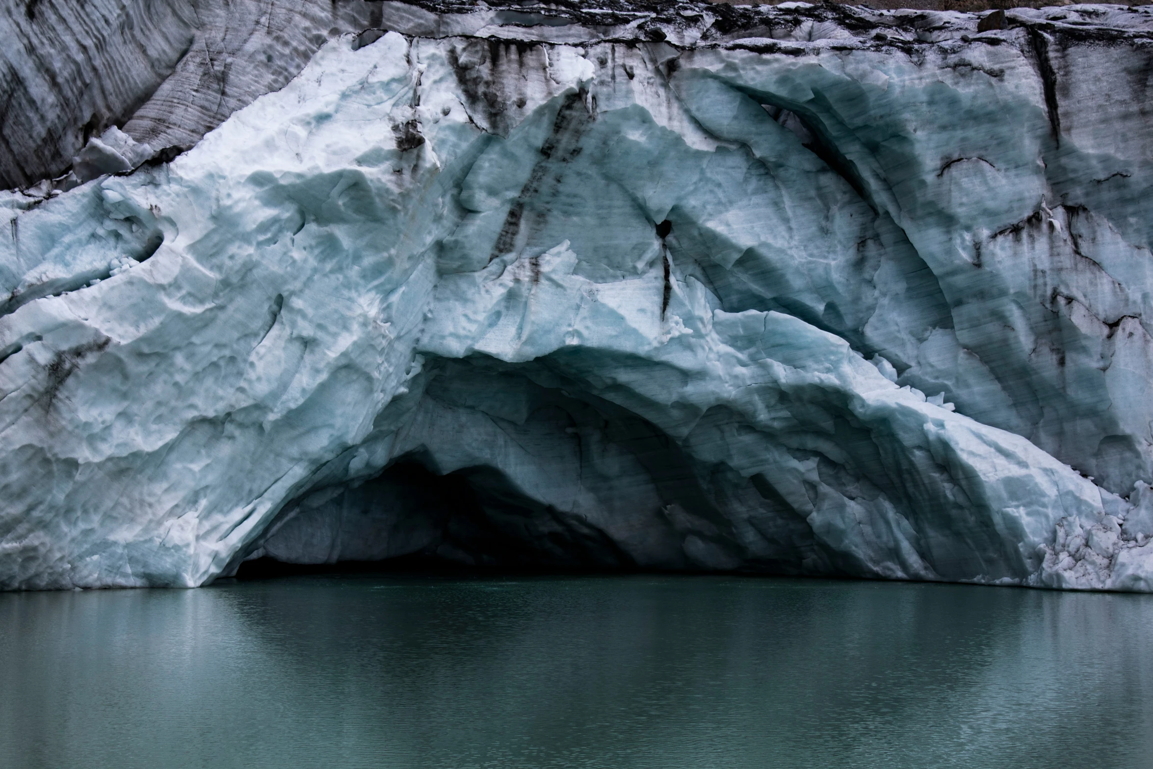 an iceberg in a lake with a boat on it