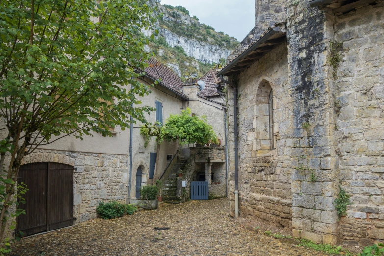 the house is built in stone and has an arched door