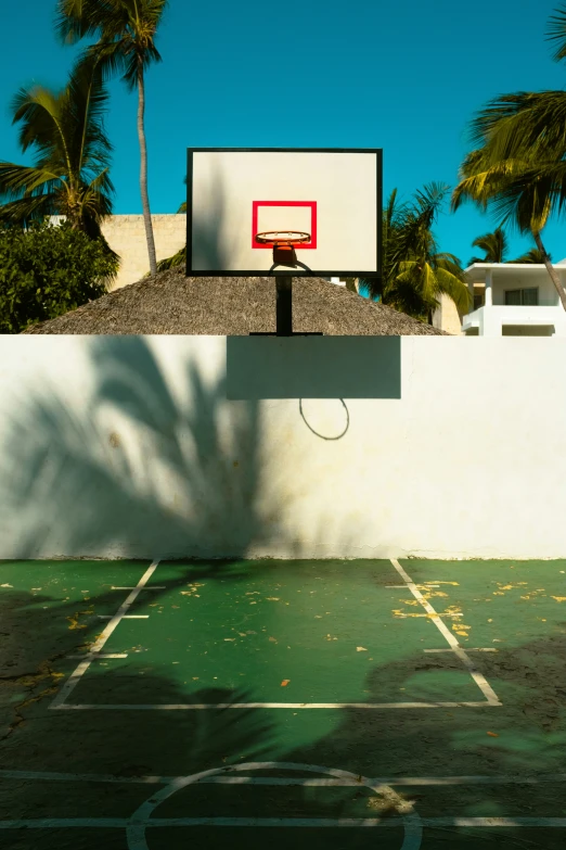 a boy plays basketball on an outdoor court