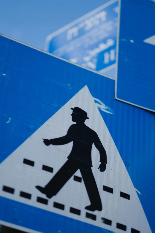 a street sign with a man walking on it