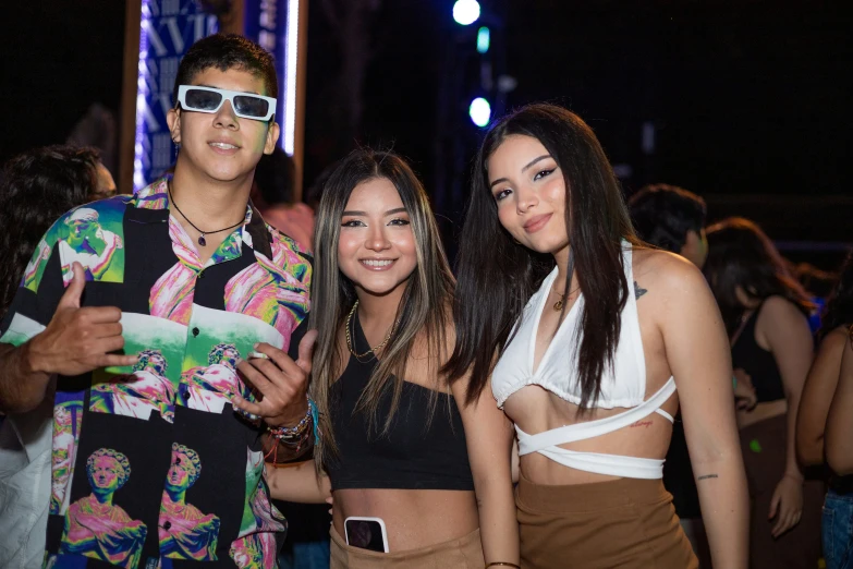 three young people dressed in bathing suits at a party